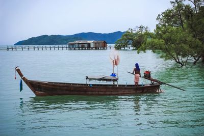 Rear view of man in boat sailing in river