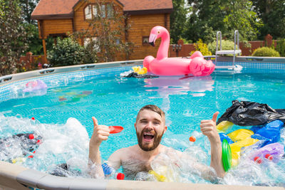 Portrait of happy friends in swimming pool