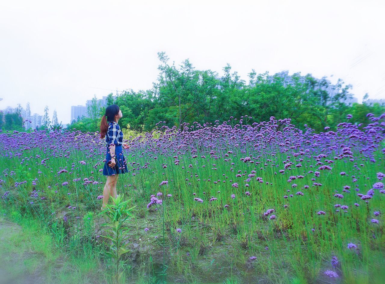 FULL LENGTH OF WOMAN STANDING ON FIELD DURING RAINY DAY