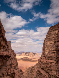 View of rock formations against cloudy sky