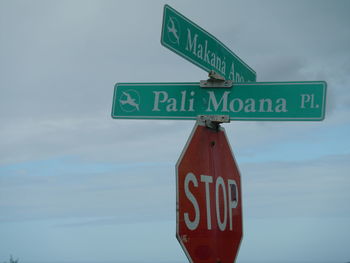 Low angle view of street sign against sky