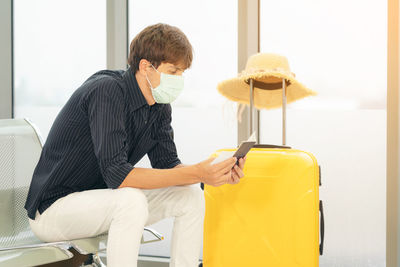 Young man sitting on chair