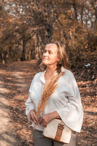 Woman standing by tree