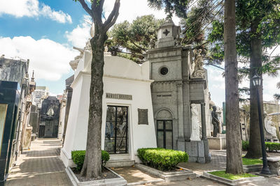 Panoramic view of trees and buildings against sky