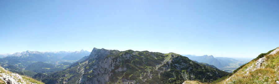 Scenic view of mountains against clear blue sky