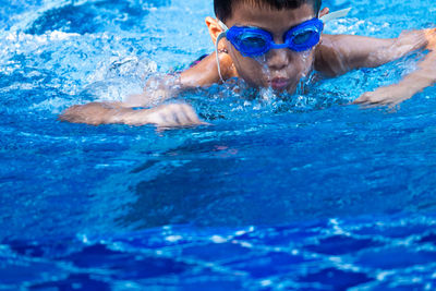 Boy swimming in pool