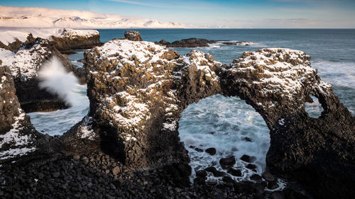 Rock arch by the sea in winter