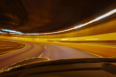 Blurred motion of illuminated lights in tunnel