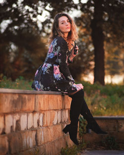 Portrait of beautiful woman against trees