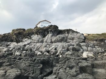 Low angle view of rock against sky