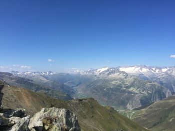 Scenic view of mountains against clear blue sky