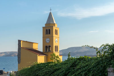 Church by building against sky