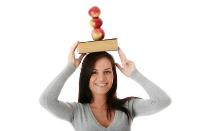 Portrait of a smiling young woman against white background