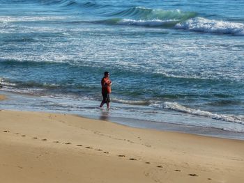 Full length of man walking at beach