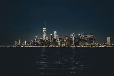 Illuminated buildings against sky at night