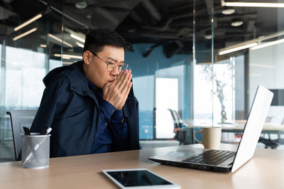 Businesswoman using laptop at office