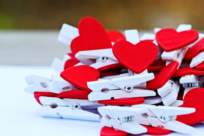 Close-up of heart shape clothespins on table outdoors