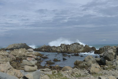 Panoramic view of rocks on beach against sky