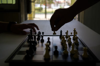 Low angle view of people playing on chess board