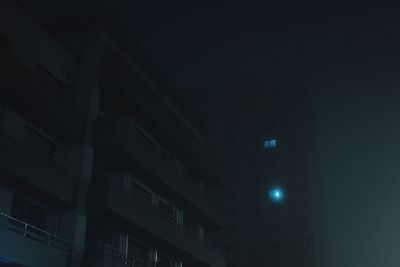 Low angle view of illuminated building against sky at night