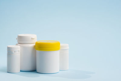 Close-up of pills in bottle against blue background
