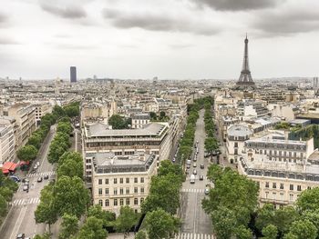 Eiffel tower amidst buildings in city