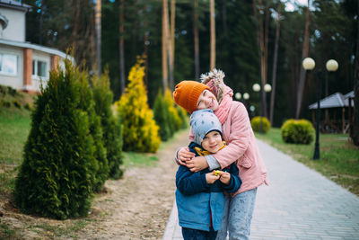 Brother and sister have fun and laugh outside in autumn in the park