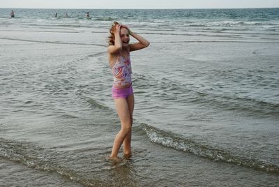 Full length of girl on shore at beach