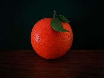 Close-up of fruits on table against black background