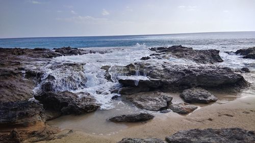 Scenic view of sea shore against sky