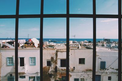 View of city by sea against sky