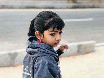 Portrait of cute girl standing outdoors