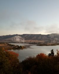 Scenic view of lake and mountains against sky