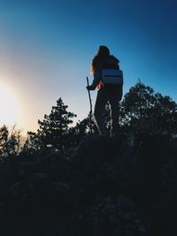 Low angle view of silhouette woman standing against clear sky