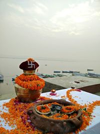 Lota and religious offerings at assi ghat against ganges river