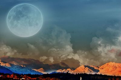 Scenic view of mountains against sky at night