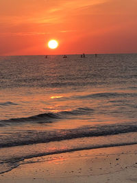 Scenic view of sea against romantic sky at sunset