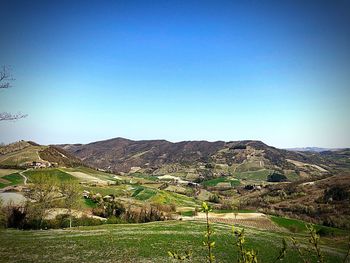 Scenic view of mountains against clear blue sky