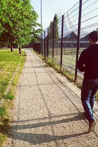 Woman walking on footpath