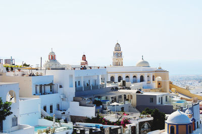 Buildings in city against clear sky