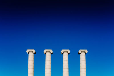 Low angle view of lighthouse against clear blue sky