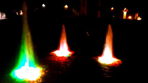 Close-up of lit candle in dark room