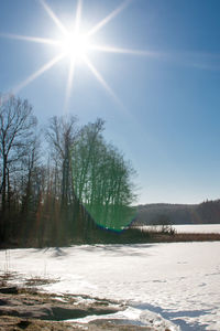 Scenic view of beach against sky on sunny day