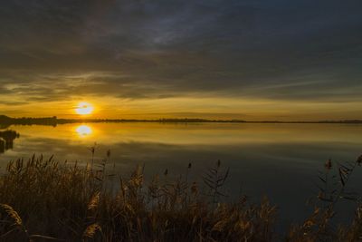 Scenic view of lake against romantic sky at sunrise 