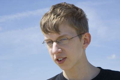Close-up portrait of a boy against sky
