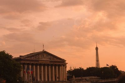 Building against cloudy sky at sunset