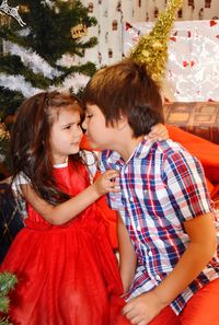 Cute siblings face to face at home during christmas