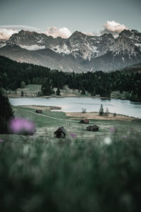 Scenic view of lake by mountains against sky