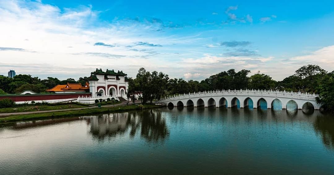 architecture, built structure, sky, water, building exterior, cloud - sky, building, nature, tree, waterfront, plant, reflection, no people, lake, history, the past, travel destinations, blue, outdoors, arch bridge