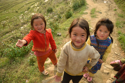 High angle portrait of smiling girl on grass